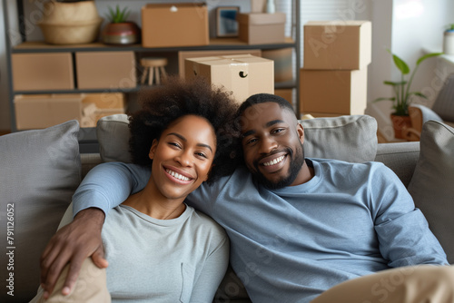 Smiling Couple Relaxing on Sofa During Moving Day photo