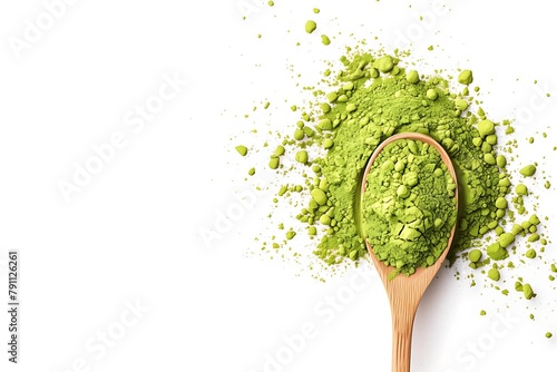 Matcha powder on a wooden spoon against a white background, in a close-up top view.
