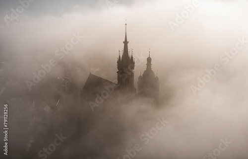 Saint Mary Basilica (Mariacki Church) during foggy sunrise, Krakow, Poland photo