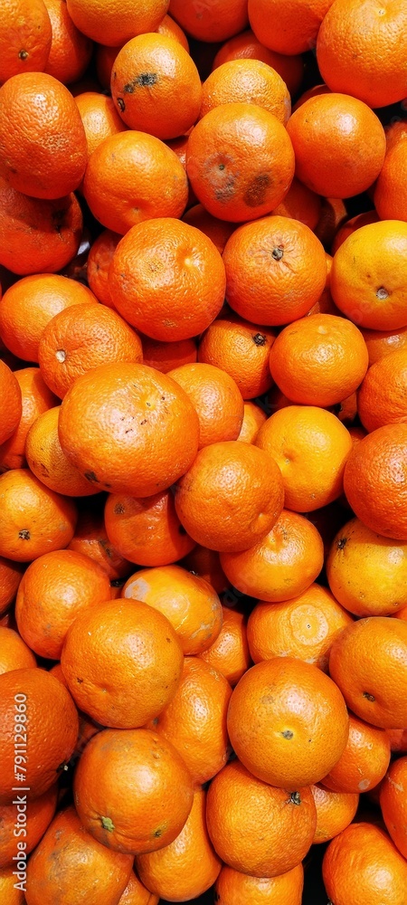 there are many oranges that are stacked up together on the table