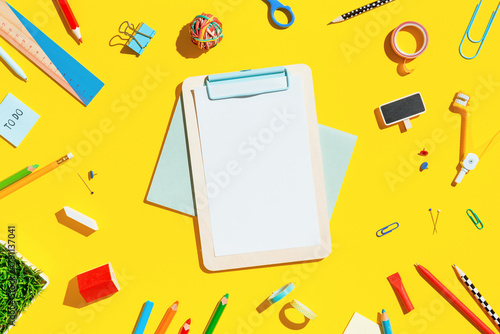 School supplies on a yellow background.	
