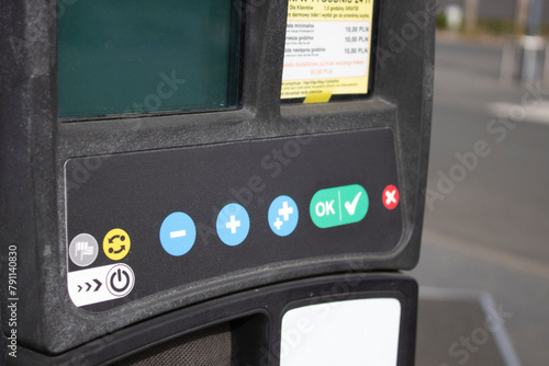 Parking machine on a city street. Car parking payment system photo