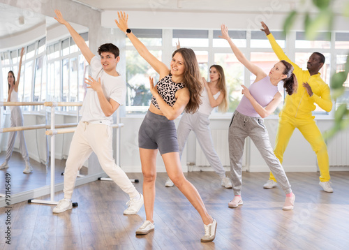 Group of men and women rehearsing hip hop dance in dance studio