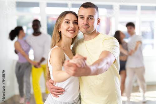 Woman learn to dance couples latin dance, energetic and fast salsa in modern dance salon