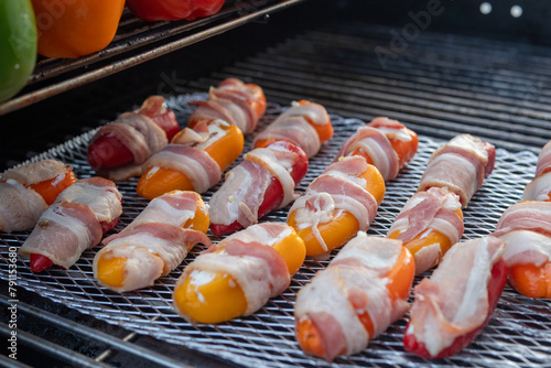 bacon wrapped stuffed jalapenos on the grill