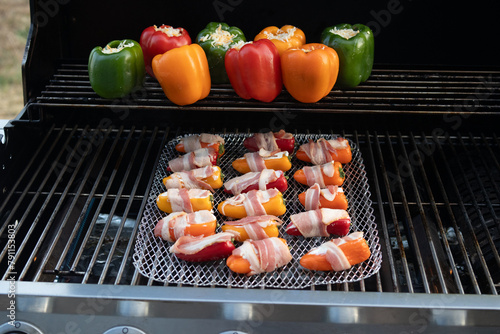 bacon wrapped jalapenos and stuffed peppers on the grill