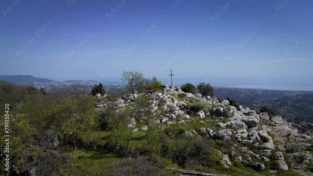 Overflight of a cliff with a Christian cross overlooking the mountain, view of the Mediterranean Sea and Nice tourist city in the south of France, 4K drone Overflight of a cliff with a Christian cross overlooking the mountain, view of the Mediterranean Sea and Nice tourist city in the south of France, 4K drone