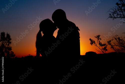 Casal se beijando no pôr do sol