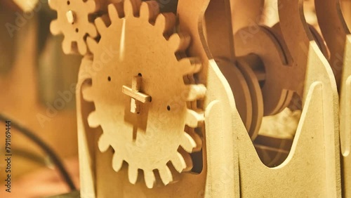 Wooden mechanism that consists of several gears photo