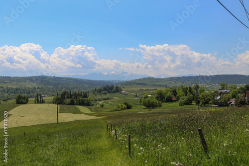 A beautiful panorama of vast Polish meadows against the background of mountains in the Lesser Poland Voivodeship. photo