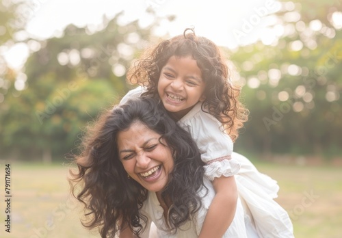 Joyful Indian Mother and Daughter Laughing Together in the Park