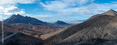 Panoramic view on colourful remote basal hills and mountains of Massif of Betancuria as seen from observation point, Fuerteventura, Canary islands, Spain photo