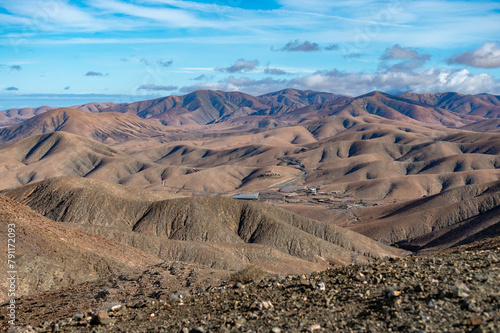 Panoramic view on colourful remote basal hills and mountains of Massif of Betancuria as seen from observation point, Fuerteventura, Canary islands, Spain photo