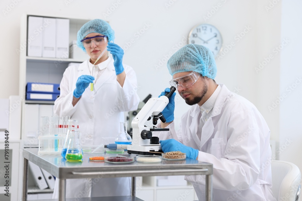 Quality control. Food inspectors checking safety of products in laboratory Quality control. Food inspectors checking safety of products in laboratory