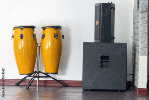 Big yellow bongos set with loud-speaker on a stage photo