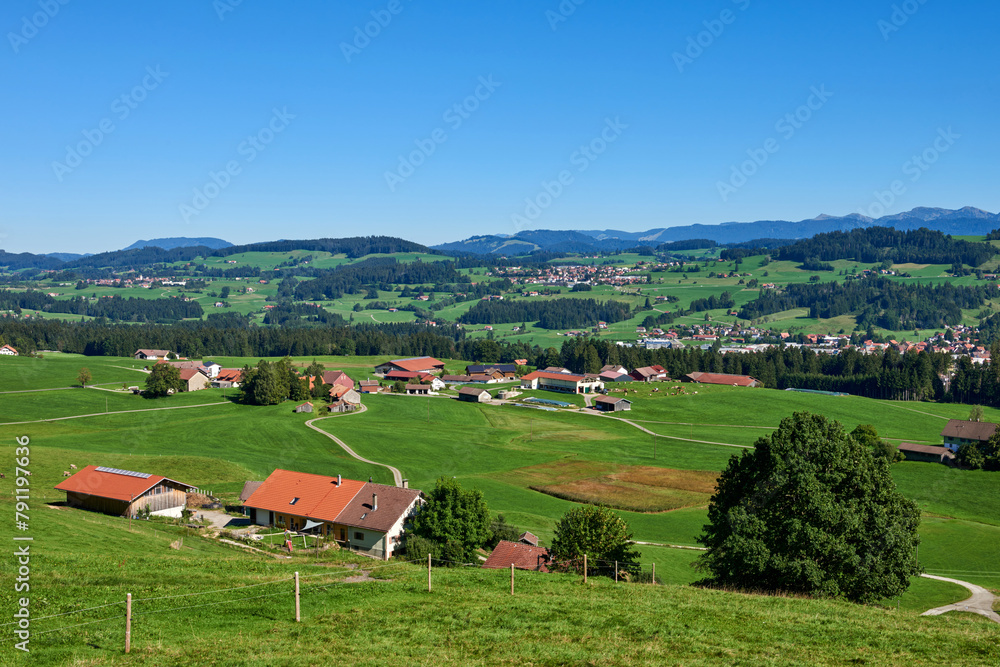 Alpine Foothills Charm: Rural Mountainside Living with Farmer's Homesteads. Mountain Countryside: Farmer's Dwellings, Pastures, and the Sky Above. Nature's Eco-Friendly Living in the Alpine Highlands