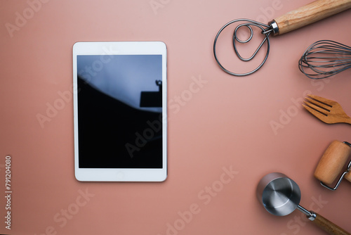 The digital tablet with cooking utensil for online recipe and menu. Flatlay