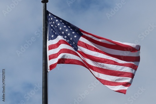 American flag on blue sky background © natalya2015