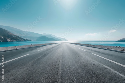Empty asphalt road by the lake
