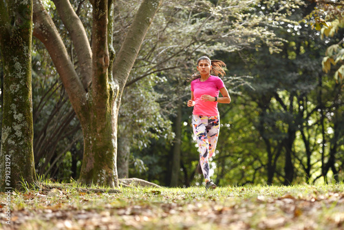 Young woman running in forest  © Fernando