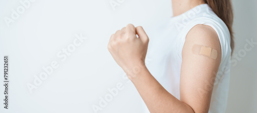 Woman with bandage after receiving vaccine. Vaccination and Immunization for Influenza, HPV, Zoster, IPD, DTP or Diphtheria, Tetanus and Pertussis, MMR, Hepatitis B, Covid  and Varicella vaccine photo