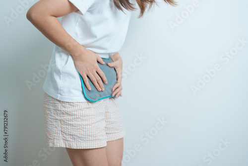 Menstruation period cycle of monthly and Stomachache concepts. woman having abdomen pain and menstrual ache with hot water bottle, illness female suffer from premenstrual ache and body Health problem