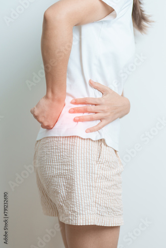 woman having back body ache during at home. adult female with muscle pain due to Piriformis Syndrome, Low Back Pain and Spinal Compression. Office syndrome and medical concept