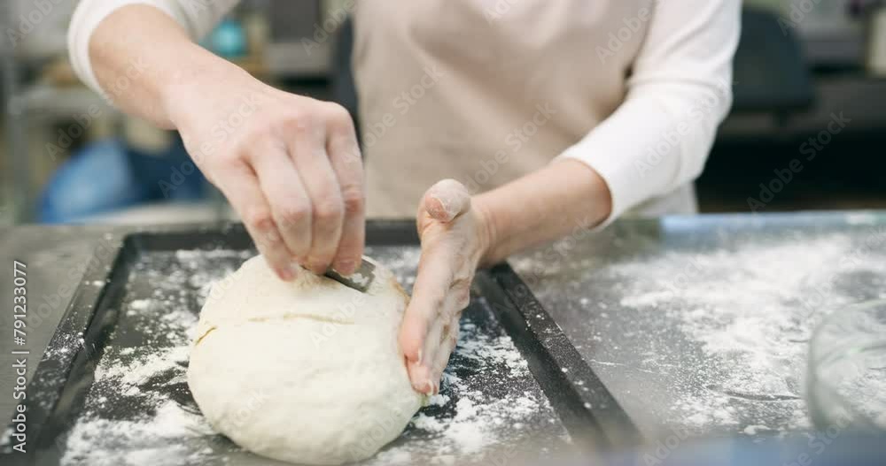 Chef, hands and blade on dough in bakery with production, process and handmade bread in restaurant or cafe. Woman, closeup and wheat in kitchen for service, culinary or pastry with sprinkle and oven Chef, hands and blade on dough in bakery with production, process and handmade bread in restaurant or cafe. Woman, closeup and wheat in kitchen for service, culinary or pastry with sprinkle and oven