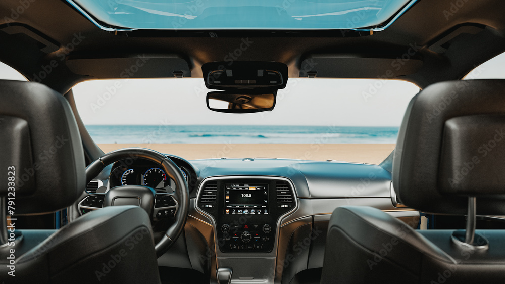 Image of the interior of a car parked on the beach..
