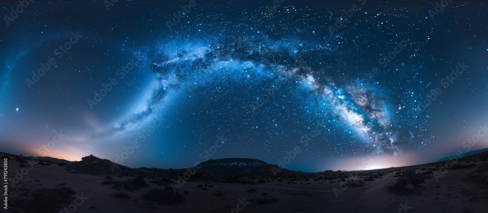 Panoramic view capturing the spectacular Milky Way galaxy and twinkling stars as seen from the summit of a majestic mountain