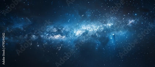 Dark blue sky filled with twinkling stars and a milky-like structure resembling a cosmic cloud photo