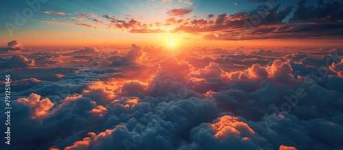 Aerial view of sunrise over white clouds with mountains