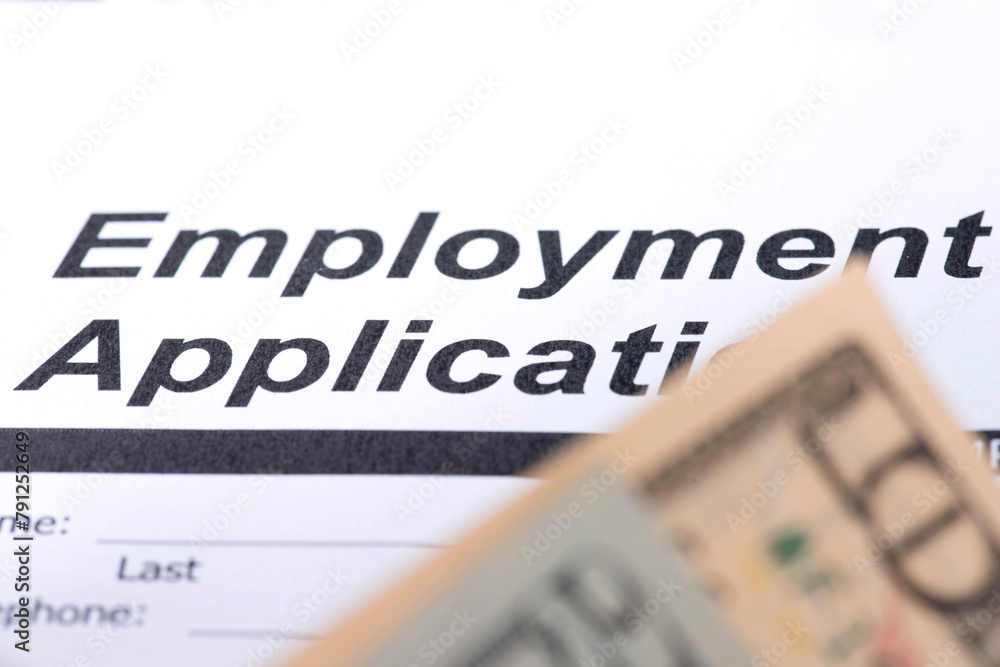 Fototapeta premium Dollar banknotes and an employment contract