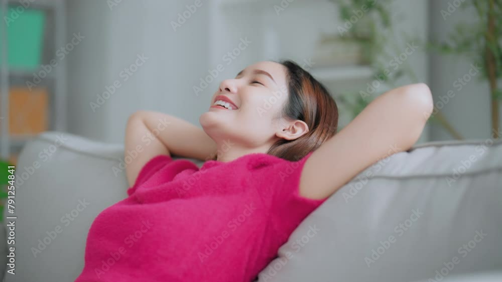 Relaxed young Asian woman enjoying rest on comfortable sofa, calm attractive girl relaxing on couch, breathing fresh air with eyes closed, meditating at home Relaxed young Asian woman enjoying rest on comfortable sofa, calm attractive girl relaxing on couch, breathing fresh air with eyes closed, meditating at home