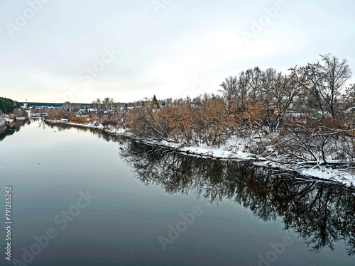 banks of the winter river covered with forest © petrovval
