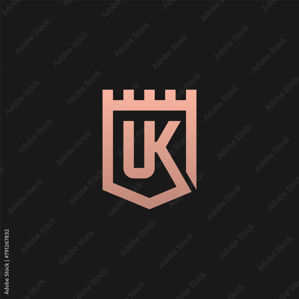 UK monogram logo inside fort shield frame - gold color. UK monogram logo inside fort shield frame - gold color.