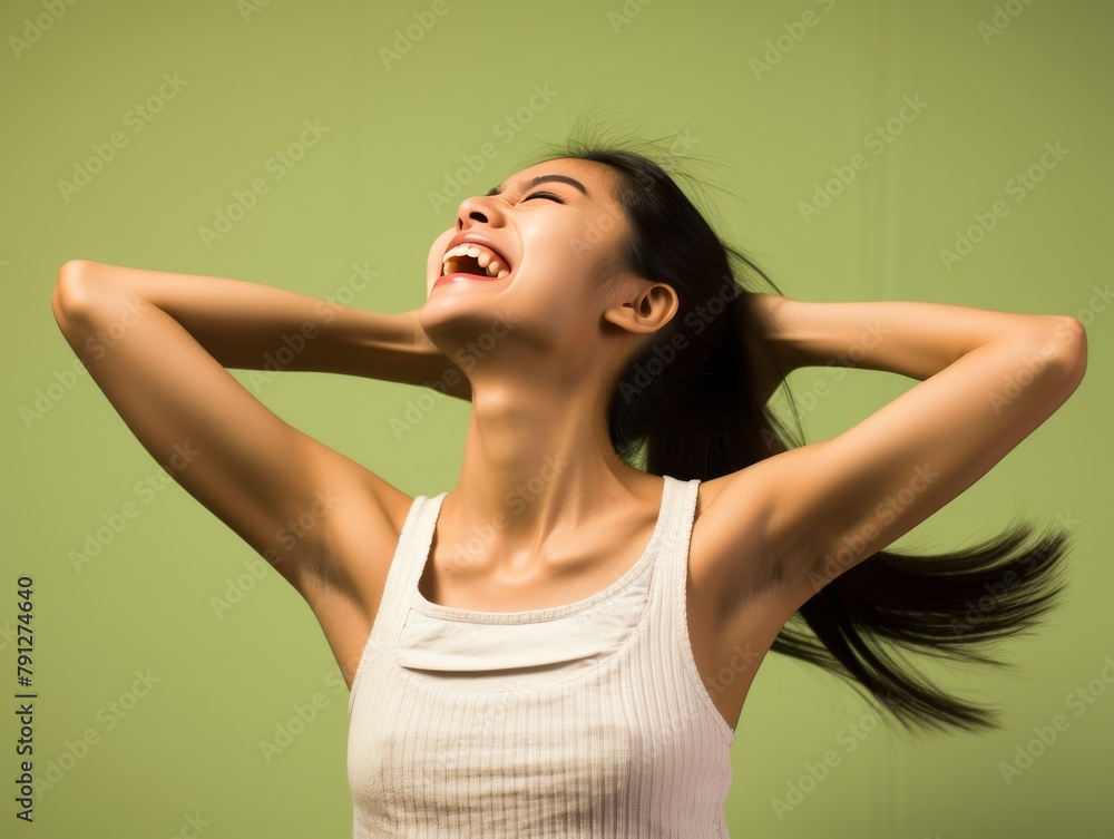Fototapeta premium A woman with curly hair is smiling and laughing