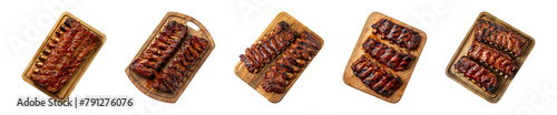 Collection of grilled spare ribs on wooden cutting board isolated on a transparent background, top view, PNG