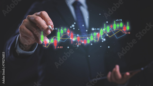 A man is drawing a graph on a screen with a digital pen. The graph is showing a stock market trend. Financial investment and stock market analysis, forecast and trading concept.