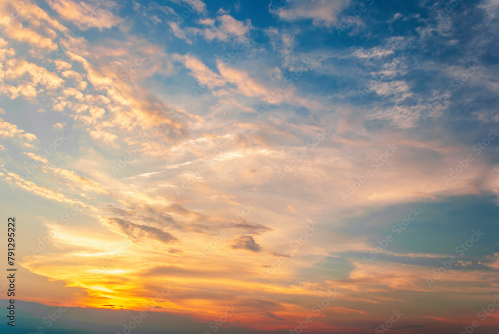 The sky is a beautiful shade of blue with a few clouds scattered throughout. The sun is setting, casting a warm glow over the horizon.