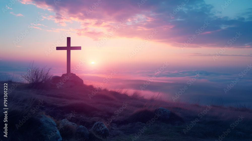 A cross is on a hillside with a beautiful sunset in the background