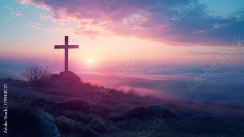 A cross is on a hillside with a beautiful sunset in the background