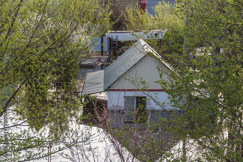 Flood in Kazakhstan. Flooded house in a dacha area. The river overflowed its banks. Cataclysms in Kazakhstan.