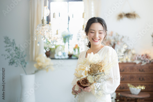 Young Japanese (Asian) woman in a wedding dress Image of a bride's wedding, including a pre-wedding shot and bridal ceremony Beautiful pose of a bride lying face down