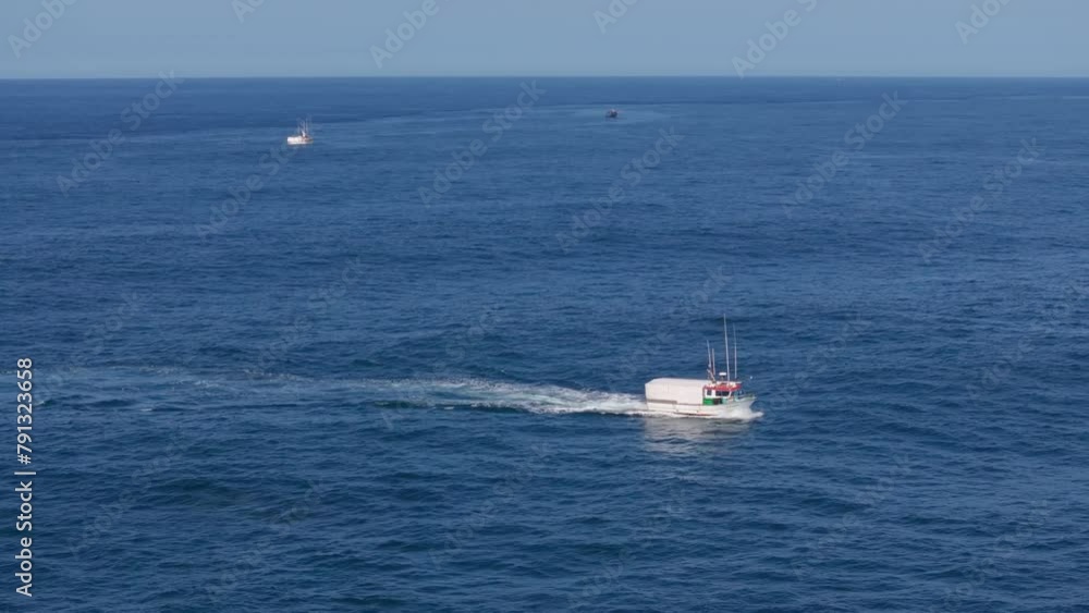 Fishing Boat Cruising In The Blue Sea In To Muxia In Spain. - aerial shot Fishing Boat Cruising In The Blue Sea In To Muxia In Spain. - aerial shot