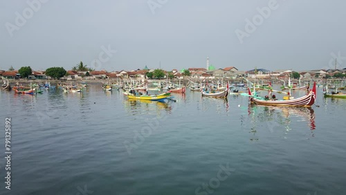 Muncar port serves as a traditional boat dock, an essential hub for the local economy and renowned as the largest port in Java. 4k aerial, drone footage photo