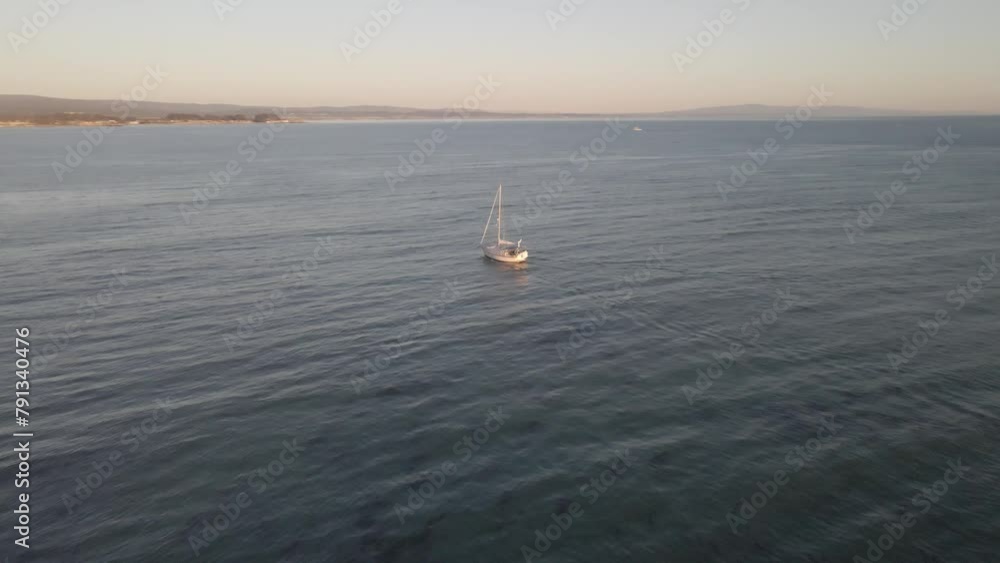 Drone flies over a boat on the water as it slowly moves out of the frame Drone flies over a boat on the water as it slowly moves out of the frame