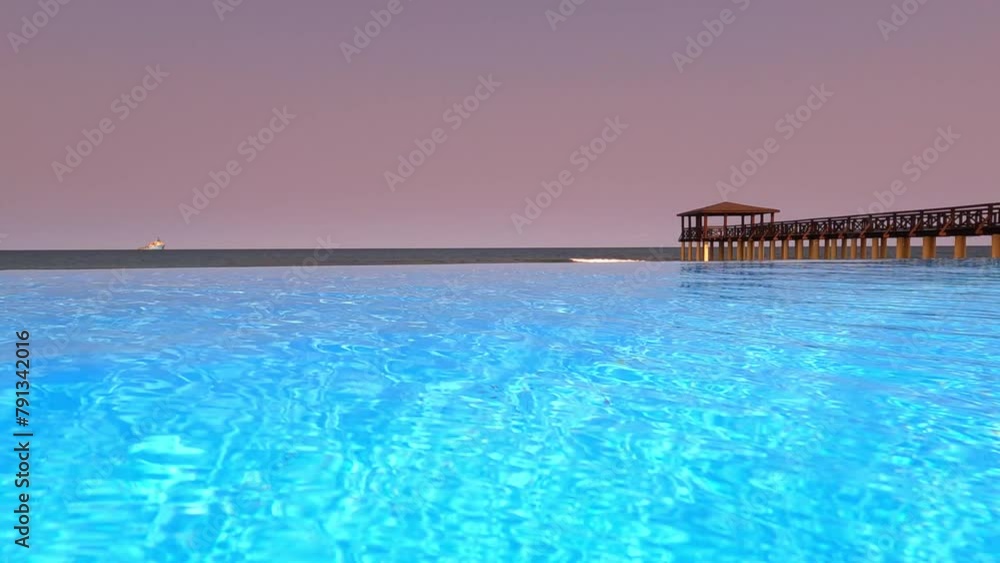 Low view from a infinity pool from a luxury hotel with the pontoon in background at São Tomé,Africa Low view from a infinity pool from a luxury hotel with the pontoon in background at São Tomé,Africa