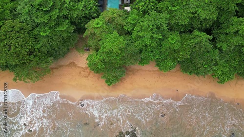 From above the waves breaking on sand , with a pool surronded by green forest at a luxury eco resort in Prince Island,Sao Tome,Africa photo