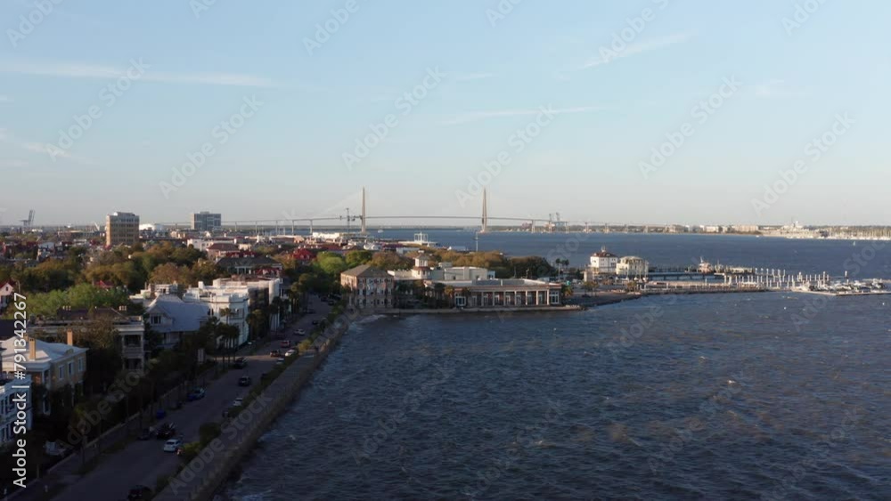 Aerial rising dolly shot out over Charleston Harbor along the historic waterfront during sunset in South Carolina. 4K Aerial rising dolly shot out over Charleston Harbor along the historic waterfront during sunset in South Carolina. 4K